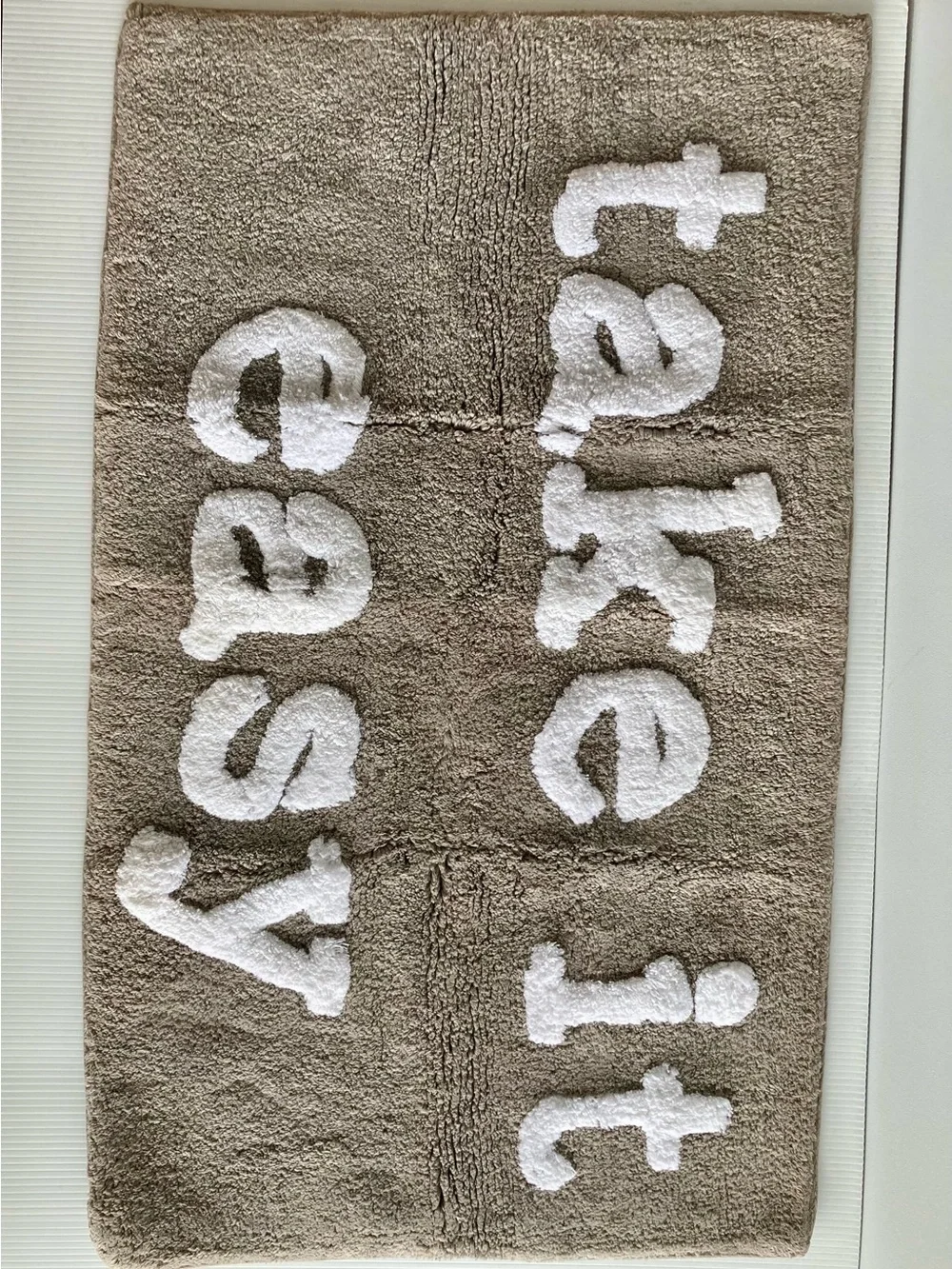 Taupe Bath Rug with White Raised 'take it easy' Text